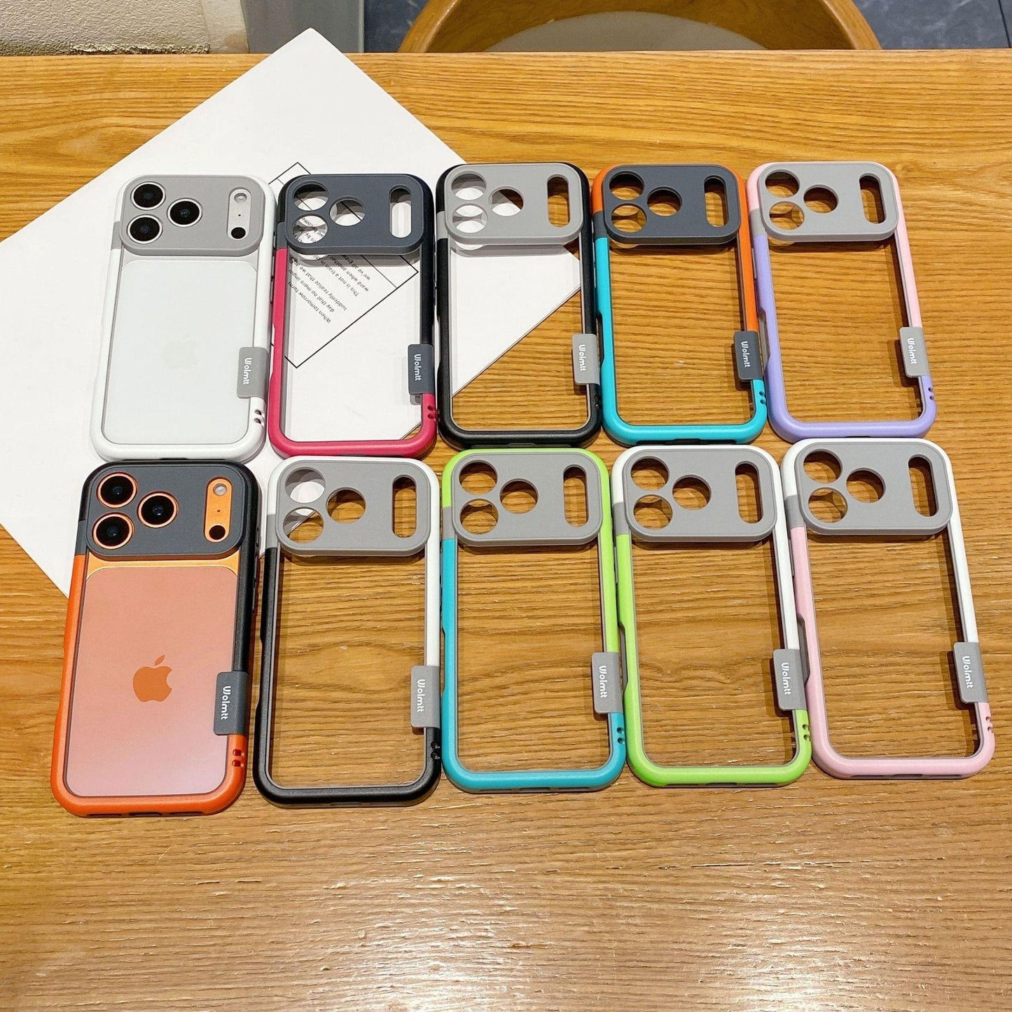 Assorted dual-color border phone cases with camera cutouts, multiple colors shown