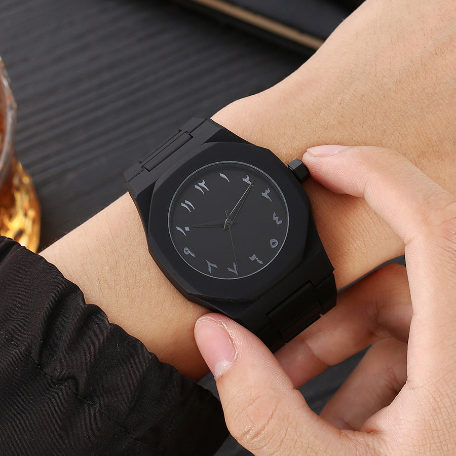 Black quartz wristwatch on wrist with round black dial and black metal link strap