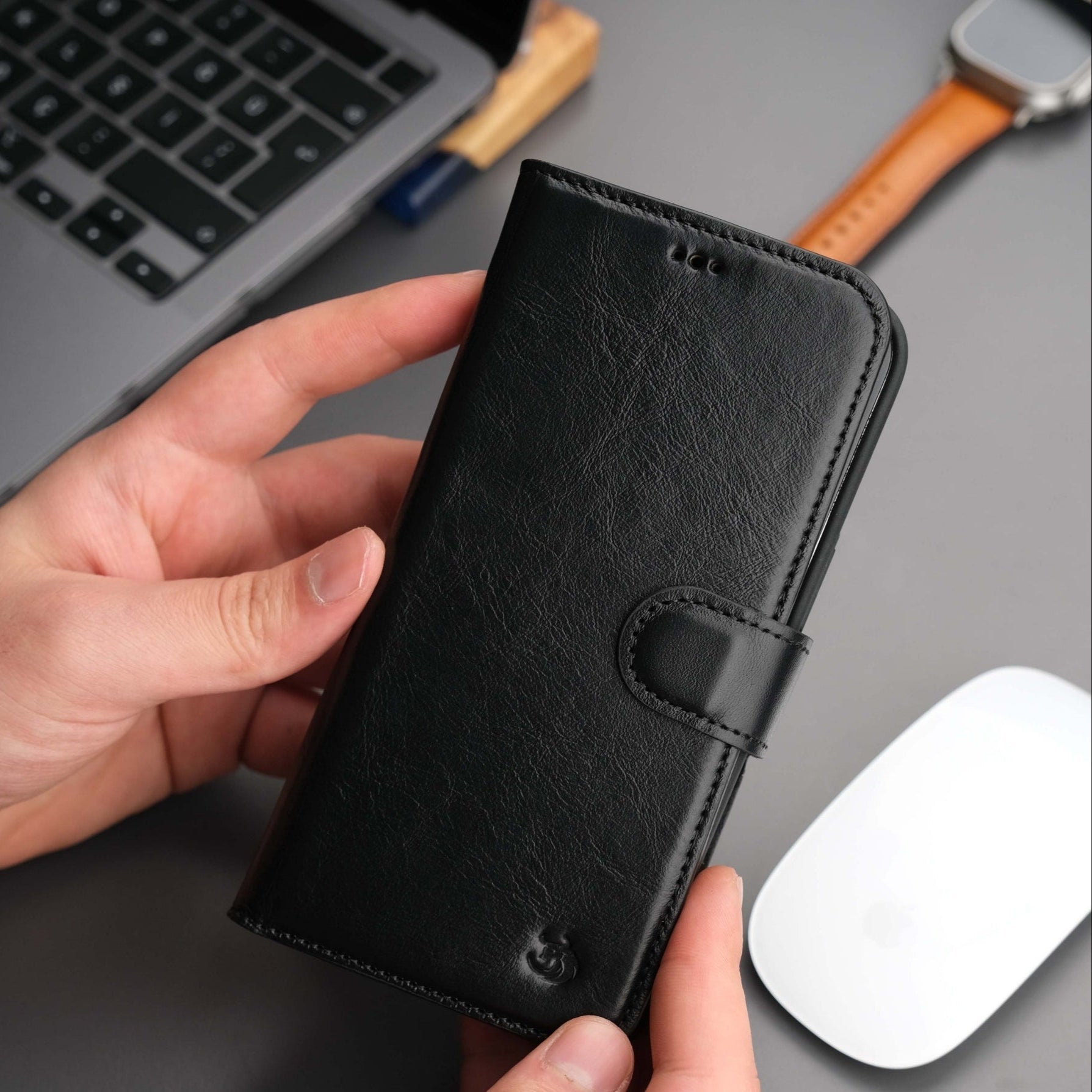 Black leather iPhone 14 Plus wallet case with folio-style front and strap