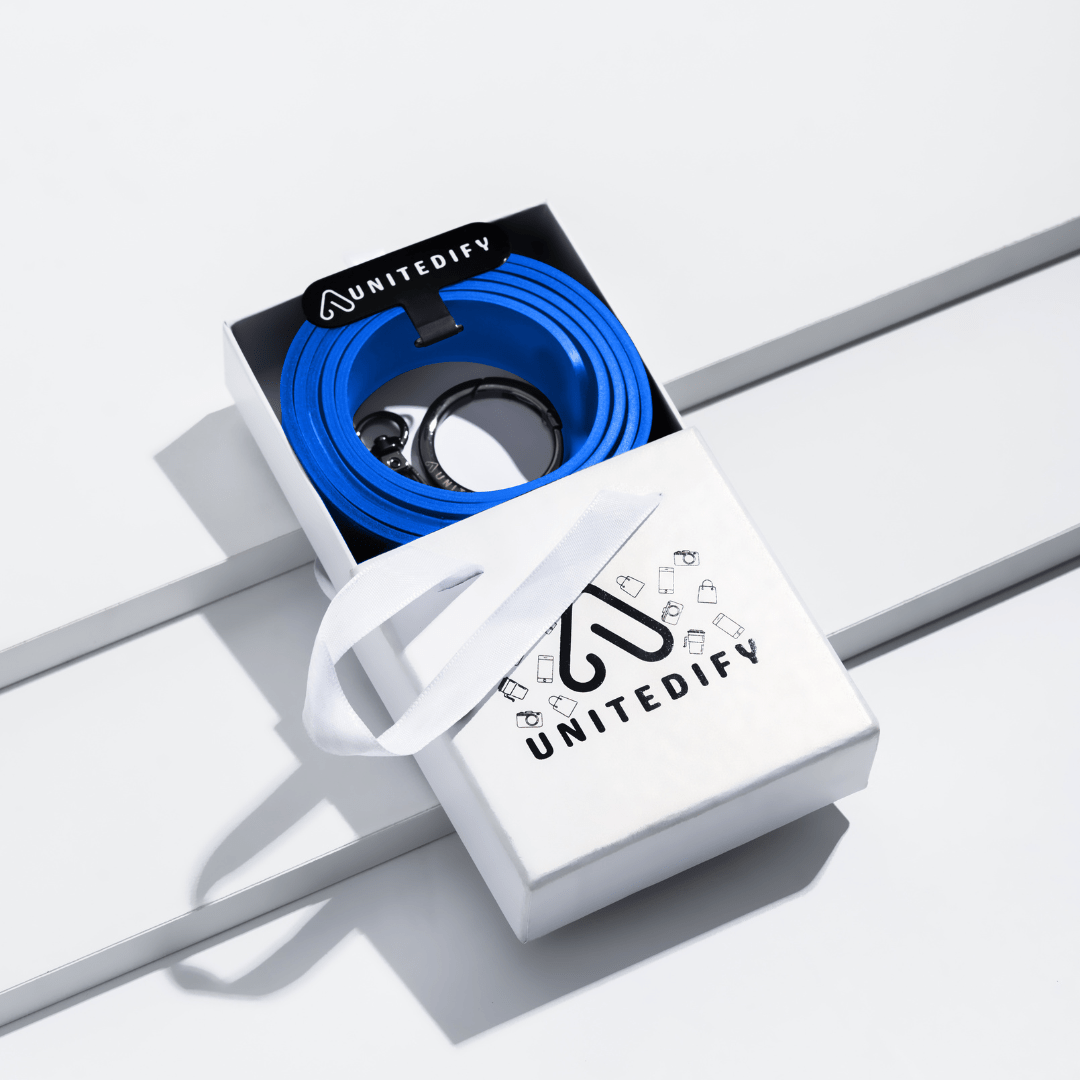 Gift box with blue coiled phone strap and white gift bag