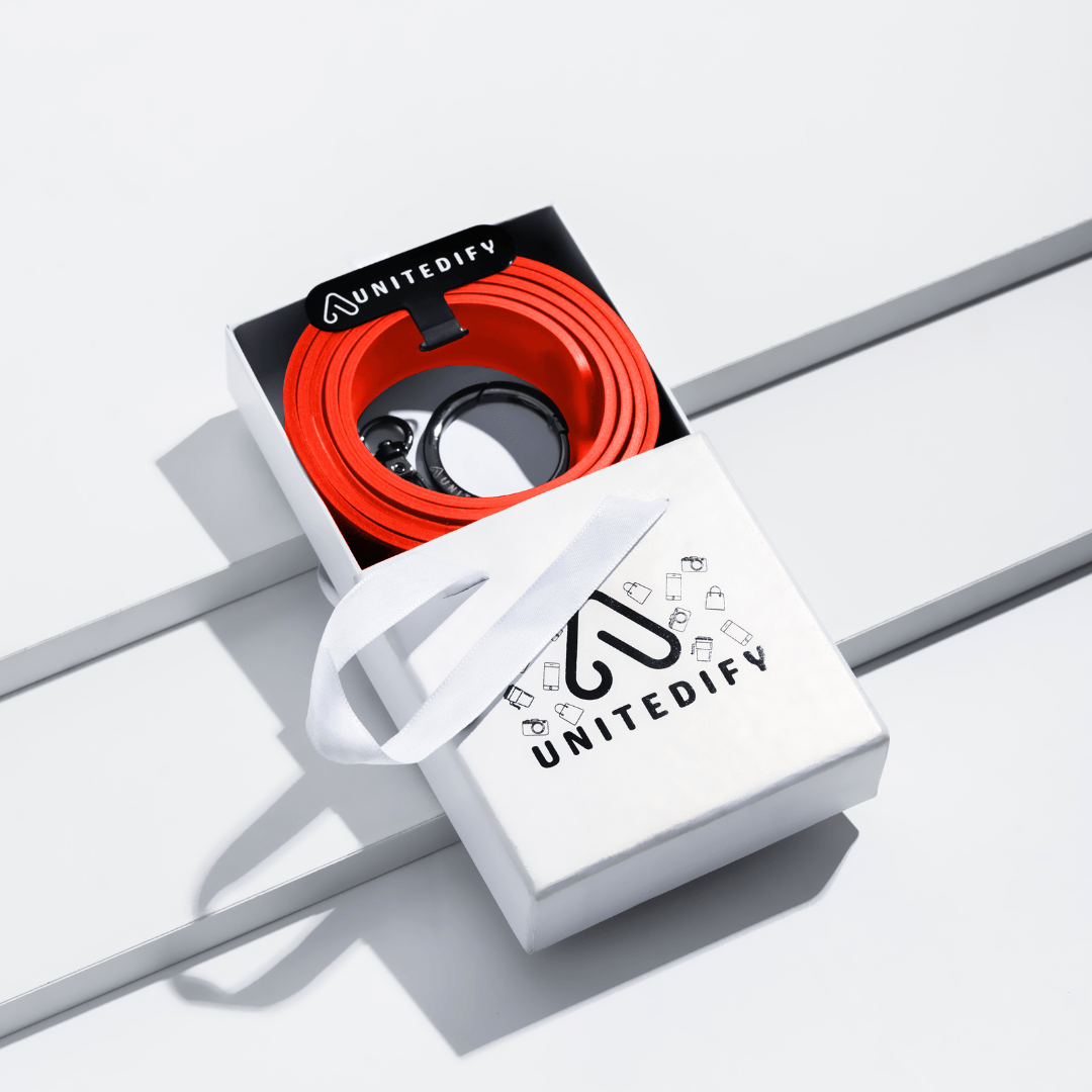 Gift box with red coiled phone strap and white gift bag