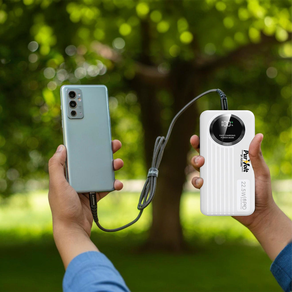 White power bank held in hand with charging cable connected to phone