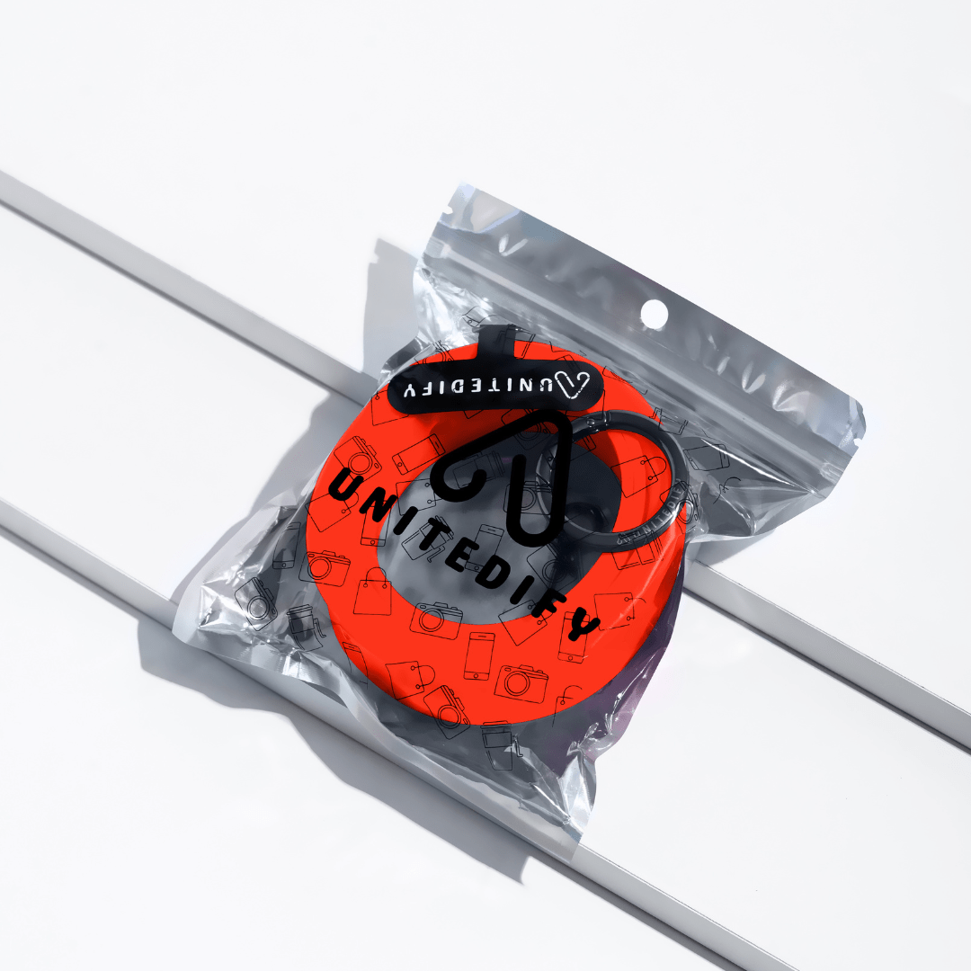 Phone strap with orange-red patterned loops, shown in a sealed polybag by Unitedify