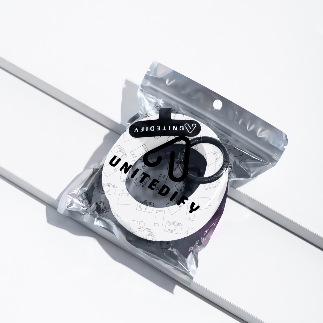 Phone strap with black patterned loops, shown in a sealed polybag by Unitedify