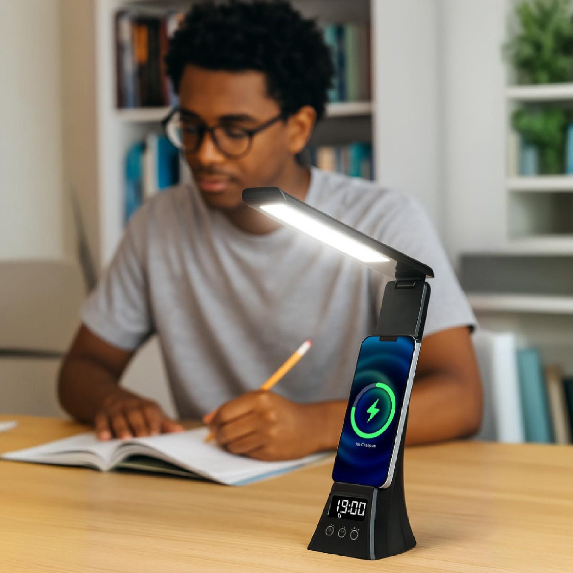 Black LED desk lamp with glowing white light, blue charging icon, and clock screen