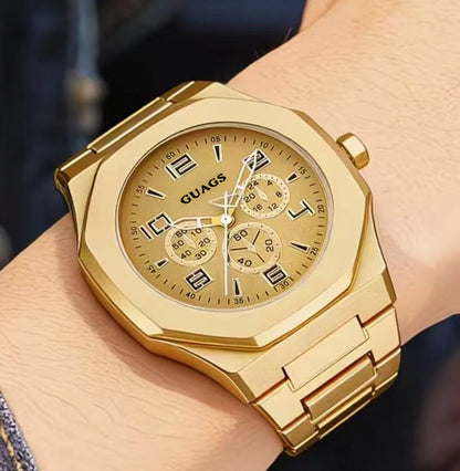 Gold quartz wristwatch with black chronograph dial worn on wrist