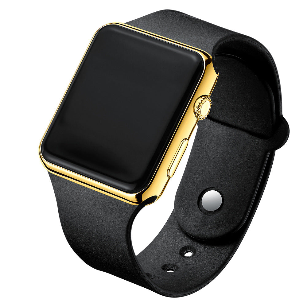 Digital electronic wristwatch with black screen, gold case, black silicone strap.