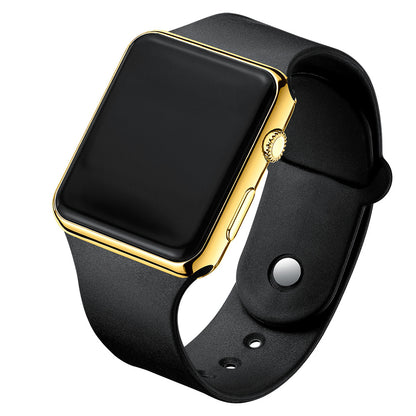 Digital electronic wristwatch with black screen, gold case, black silicone strap.