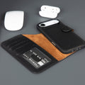 Leather iPhone wallet case with black exterior, tan lining, and card slots