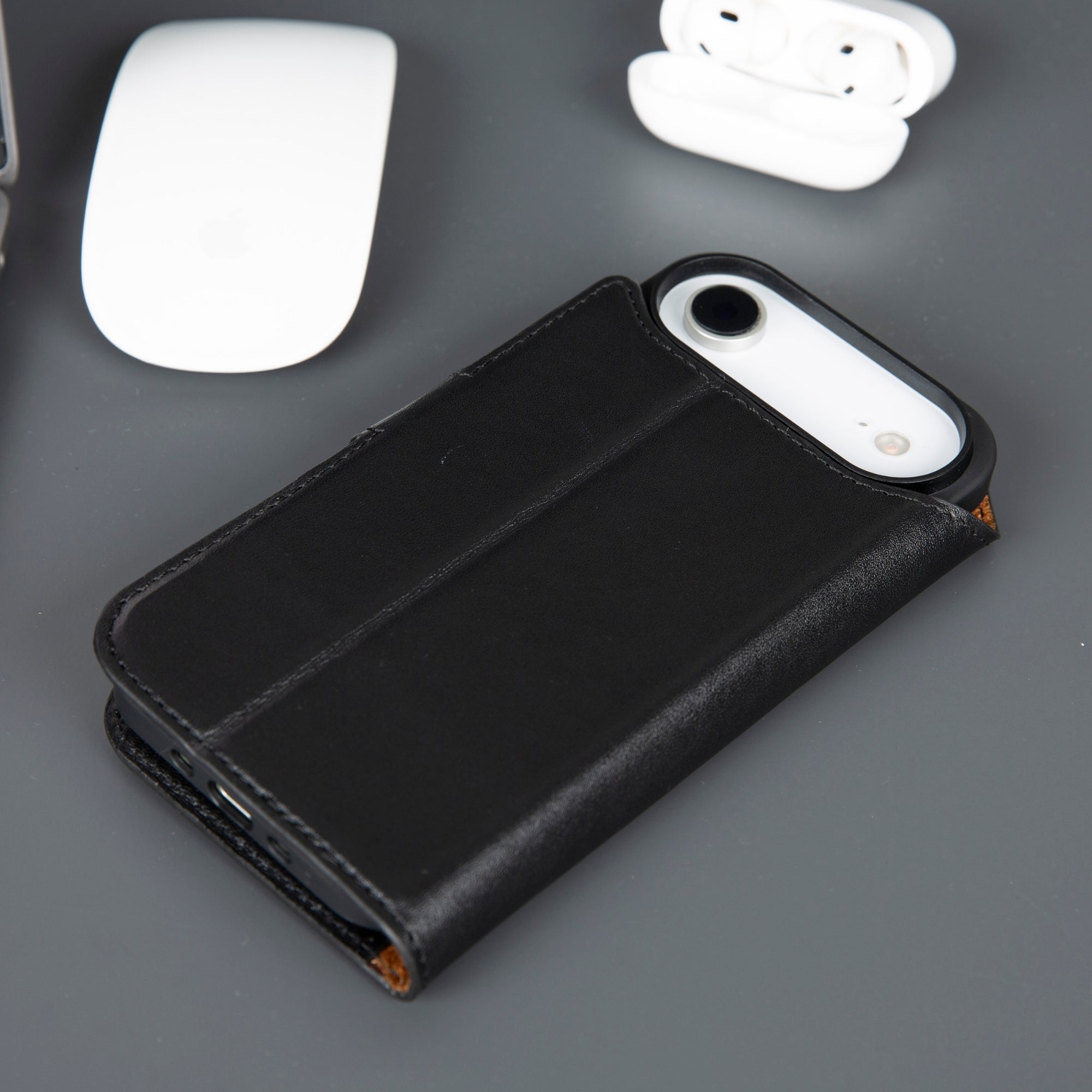 Black leather iPhone wallet case with phone back showing through cover