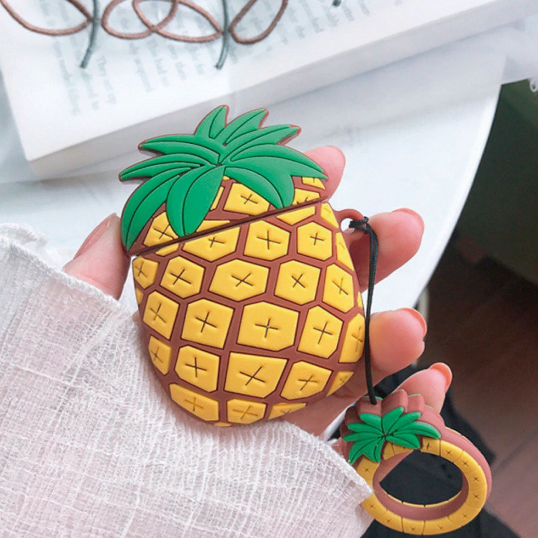 Pineapple AirPod case with green leaf top and ring strap, plus pineapple charm.
