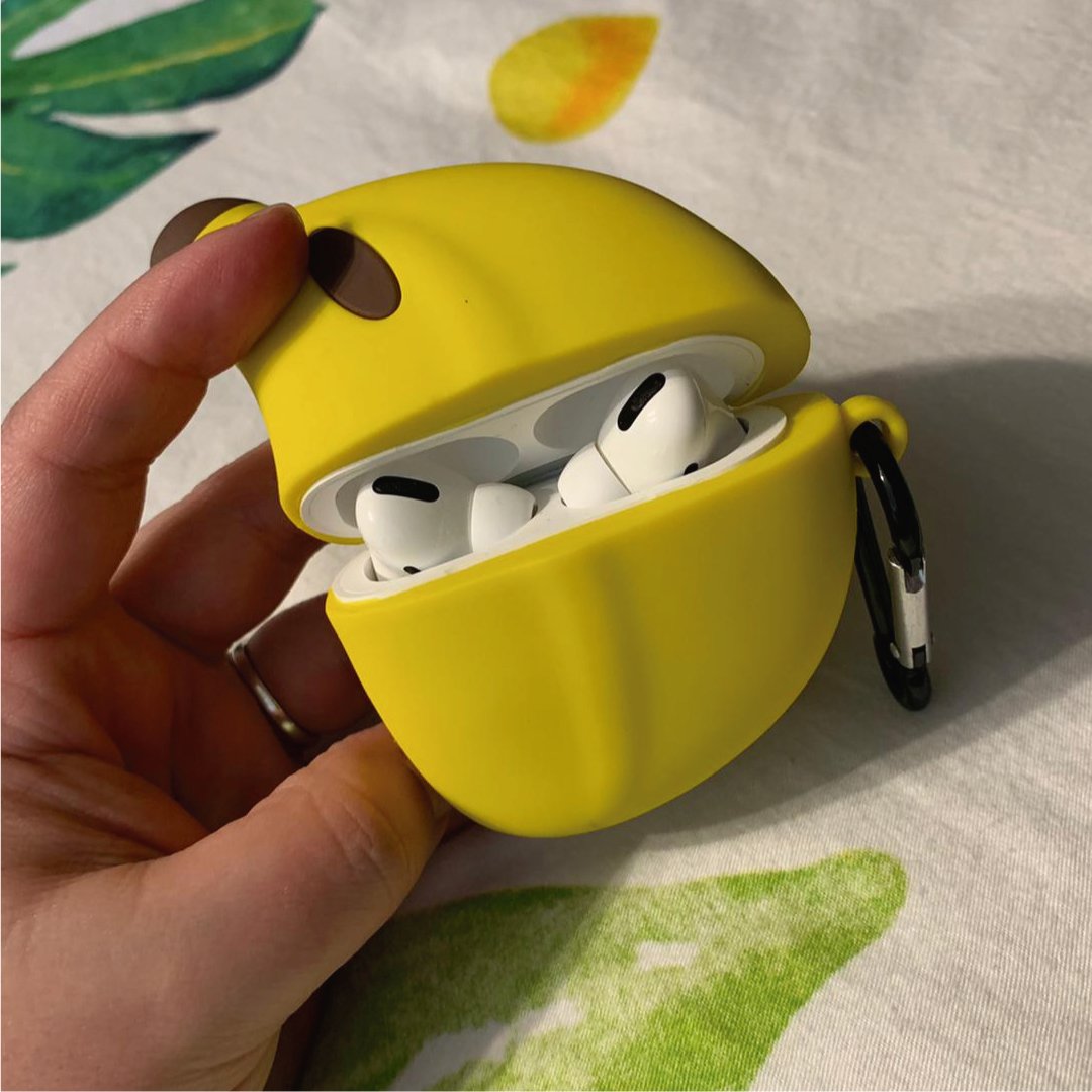 Yellow banana-shaped AirPods Pro case with brown stem, open showing earbuds.