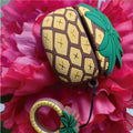 AirPod Pro case with grid pattern and teal pineapple charm