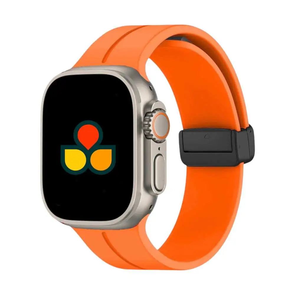 Silicone watch strap in orange with black buckle and multiple adjustment holes